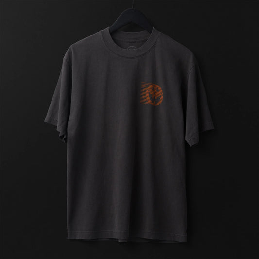 Gray t-shirt with a small orange pumpkin design on a black background