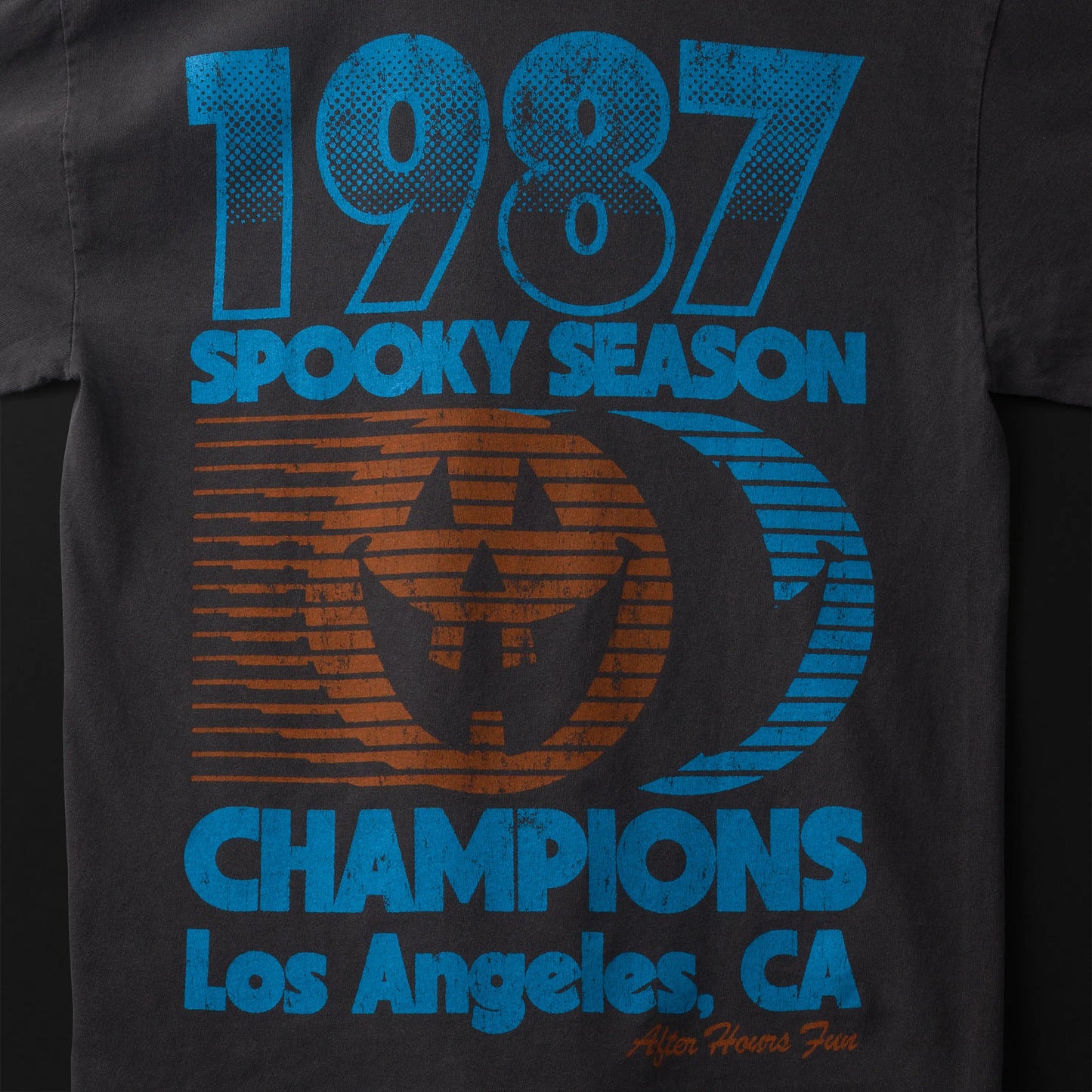 Black t-shirt with '1987 Spooky Season Champions Los Angeles, CA' text and graphic design.