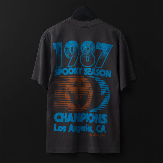 Black t-shirt with blue and orange text and graphics on a dark background